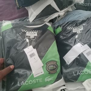 Brand new green and black Lacoste shirt size4 never worn